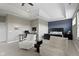 This primary suite features a tray ceiling, a navy accent wall, and plush seating at 16305 Kenora N Ln, Fortville, IN 46040
