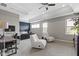 Relax in this expansive bedroom featuring plush chairs and an attached workspace at 16305 Kenora N Ln, Fortville, IN 46040