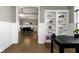 A view into the office from the dining room, showcasing seamless transition and built in shelving at 16305 Kenora N Ln, Fortville, IN 46040