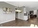 A stylish wet bar with white cabinets, a wine fridge and a granite countertop at 16305 Kenora N Ln, Fortville, IN 46040
