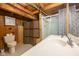 Rustic bathroom with wood paneling, shower, and a woven privacy screen at 171 Williams Trce, Plainfield, IN 46168