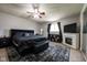Spacious bedroom featuring a black upholstered bed, decorative fireplace, and ceiling fan at 171 Williams Trce, Plainfield, IN 46168