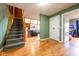 Inviting hallway featuring hardwood floors, staircase and an open view into the living room at 171 Williams Trce, Plainfield, IN 46168