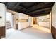 Basement kitchen with white cabinets, stone wall accent, and stairs to another floor at 171 Williams Trce, Plainfield, IN 46168