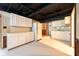 Unfinished basement kitchen area with white cabinets, stone accents, and painted flooring at 171 Williams Trce, Plainfield, IN 46168