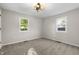 Carpeted bedroom with two windows, a ceiling fan, and neutral walls at 1903 Danbury Dr, Indianapolis, IN 46231