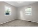 Bedroom featuring two windows that provide natural light and new carpeting at 1903 Danbury Dr, Indianapolis, IN 46231
