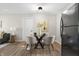 Dining room has a round glass table with cushioned chairs and hardwood floors at 1903 Danbury Dr, Indianapolis, IN 46231