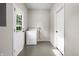 Laundry room with white washing machine and access to the backyard at 1903 Danbury Dr, Indianapolis, IN 46231