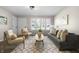 Bright and open living area with neutral tones and comfortable seating at 1903 Danbury Dr, Indianapolis, IN 46231