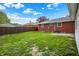 Well-manicured backyard with a fence and brick home at 1964 Mann Dr, Beech Grove, IN 46107