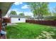 Backyard featuring a grassy lawn, garage, and a wood fence at 1964 Mann Dr, Beech Grove, IN 46107
