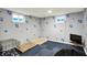 Comfortable basement area featuring natural light, dog bed, and entertainment setup at 1964 Mann Dr, Beech Grove, IN 46107