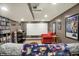 Entertainment room with projector, movie collection, and comfortable seating at 1964 Mann Dr, Beech Grove, IN 46107