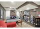 Cozy basement movie room with projector, comfortable seating, and movie collection at 1964 Mann Dr, Beech Grove, IN 46107