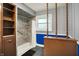 Bathroom featuring a shower, large storage cabinet, and a window at 1964 Mann Dr, Beech Grove, IN 46107