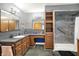 Bathroom featuring double sinks, storage cabinets, and a shower at 1964 Mann Dr, Beech Grove, IN 46107