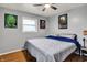 Bedroom featuring hardwood floors, ceiling fan, and unique wall decor at 1964 Mann Dr, Beech Grove, IN 46107