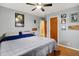 Bedroom showcases hardwood floors, a ceiling fan, and door leading to a bathroom at 1964 Mann Dr, Beech Grove, IN 46107