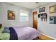 Bedroom showcases hardwood floors, a window, and comic themed wall art at 1964 Mann Dr, Beech Grove, IN 46107