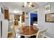 Cozy dining area features a wooden table, white chairs, and warm wood flooring at 1964 Mann Dr, Beech Grove, IN 46107
