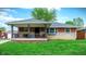 Charming single-story brick home featuring a cozy front porch and well-maintained lawn at 1964 Mann Dr, Beech Grove, IN 46107