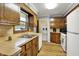 Well-lit kitchen features wood cabinets, countertop space and efficient appliance placement at 1964 Mann Dr, Beech Grove, IN 46107