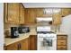 Compact kitchen features essential appliances for easy meal preparation at 1964 Mann Dr, Beech Grove, IN 46107