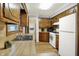 Functional kitchen with wood cabinets, essential appliances, and optimized workspace at 1964 Mann Dr, Beech Grove, IN 46107