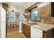 Efficient kitchen layout connects to a dining area with a view to the exterior at 1964 Mann Dr, Beech Grove, IN 46107