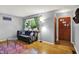 Cozy living room with hardwood floors, a comfortable sofa, and ample natural light from the window at 1964 Mann Dr, Beech Grove, IN 46107