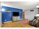 Stylish living room features a striking blue accent wall, hardwood floors, and contemporary decor at 1964 Mann Dr, Beech Grove, IN 46107