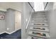 Carpeted steps leading up to the next level in a gray interior at 1964 Mann Dr, Beech Grove, IN 46107