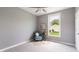 Bedroom with a window, neutral walls and carpet, and a side chair at 201 N 5Th St, Elwood, IN 46036