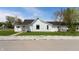 A quaint home featuring white siding, a dark roof, and a neatly maintained yard at 201 N 5Th St, Elwood, IN 46036