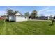 Home exterior with a white exterior, green grass, and neighborhood view at 201 N 5Th St, Elwood, IN 46036