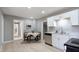 Well-lit kitchen with stainless steel appliances, white cabinetry, and open layout at 201 N 5Th St, Elwood, IN 46036