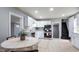 Spacious kitchen featuring modern appliances, white cabinets, and a dining area at 201 N 5Th St, Elwood, IN 46036