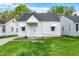 Charming single-Gathering home features a well-manicured lawn and a classic white facade with awning-covered windows at 2015 S Hackley St, Muncie, IN 47302