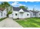 Quaint single-Gathering home with gravel driveway and white facade featuring awnings, complemented by lush green lawn at 2015 S Hackley St, Muncie, IN 47302