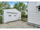 Exterior detached garage with a white door and stone ground at 2015 S Hackley St, Muncie, IN 47302