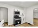 Well-lit kitchen featuring stainless steel appliances and modern white cabinetry at 2015 S Hackley St, Muncie, IN 47302