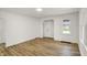 Bright, newly renovated living room featuring modern wood floors, fresh paint, and plenty of natural light at 2015 S Hackley St, Muncie, IN 47302