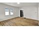 Inviting living room with modern wood floors, neutral paint, and abundant natural light from the large windows at 2015 S Hackley St, Muncie, IN 47302