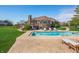 Expansive backyard with a pool, deck, mature trees, and view of the brick house at 2015 Saint Andrews Ct, Franklin, IN 46131