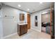 Bathroom featuring a wood door, tiled floor, and vanity with wall shelves at 2015 Saint Andrews Ct, Franklin, IN 46131