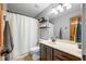 Neutral bathroom featuring a vanity with dark wood cabinets, neutral countertop and a shower-tub combination with a white shower curtain at 2015 Saint Andrews Ct, Franklin, IN 46131