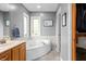 Bathroom with large corner tub, tile floors, and bright natural light at 2015 Saint Andrews Ct, Franklin, IN 46131