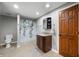 A bathroom with a wood door, tiled floor, and a vanity and toilet at 2015 Saint Andrews Ct, Franklin, IN 46131