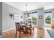 Bright dining area boasts a wooden table with views from the large windows overlooking a serene outdoor setting at 2015 Saint Andrews Ct, Franklin, IN 46131